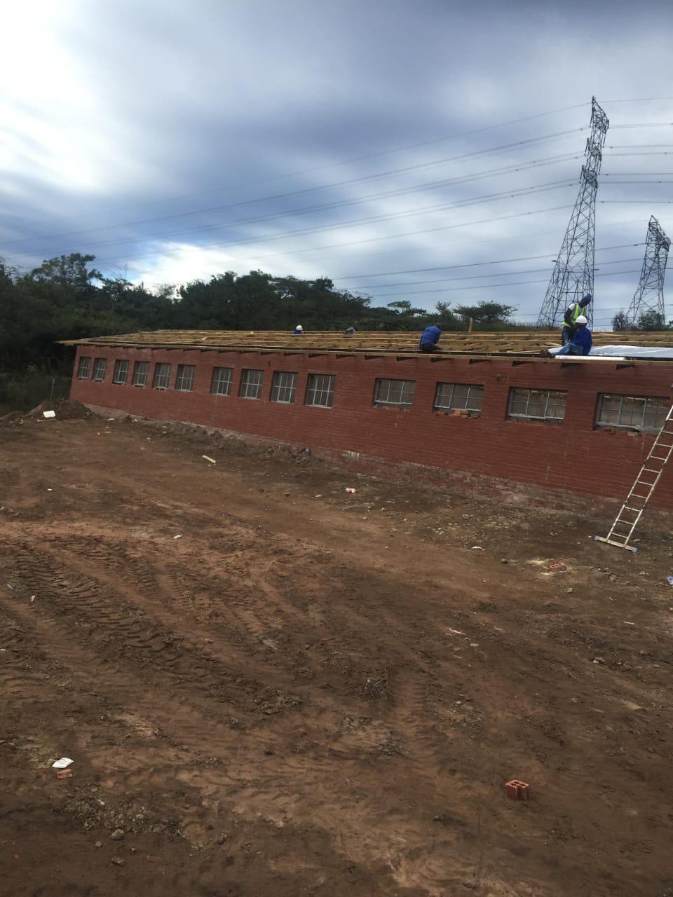 Roof installation team working on commercial building