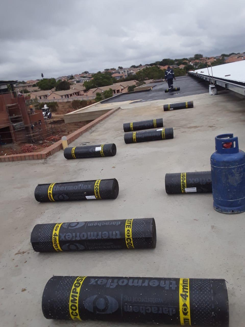 Thermoflex waterproofing rolls laid out on commercial roof