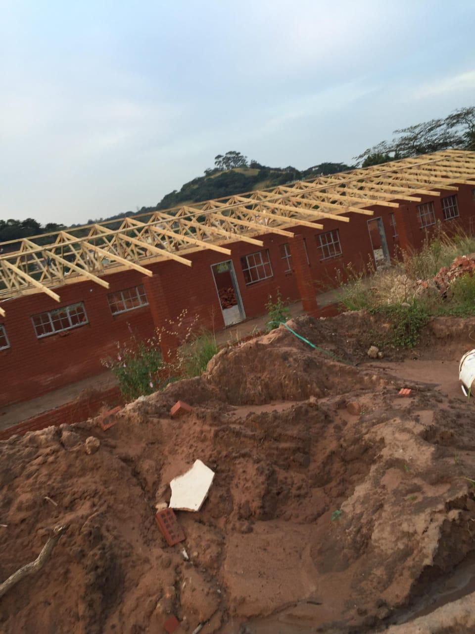 New roof truss structure on brick building