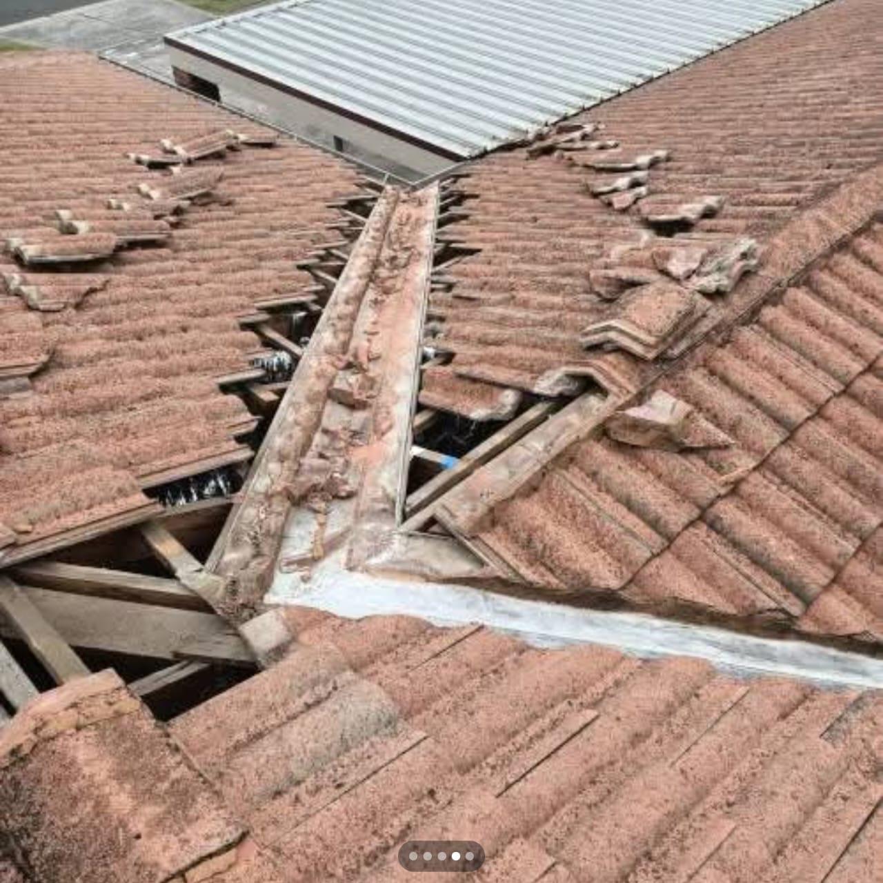Storm-damaged tile roof prepared for repair